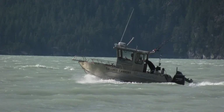 An aluminum fishing boat cruising through waves near Bella Coola, BC