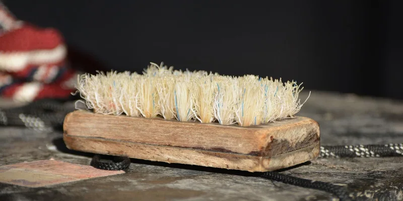Detailed shot of an old wooden scrubbing brush on a rustic surface