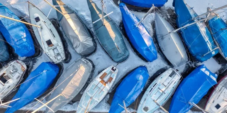 Aerial shot of sailboats in winter storage wrapped in protective coverings in Lake City, MN