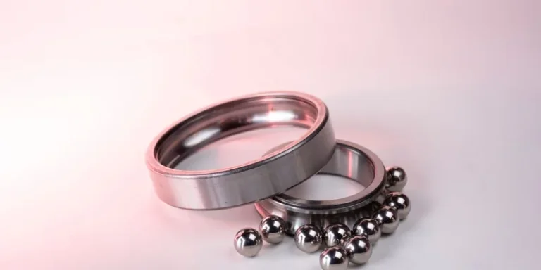 Detailed image of shiny metal bearings and rings on a white background