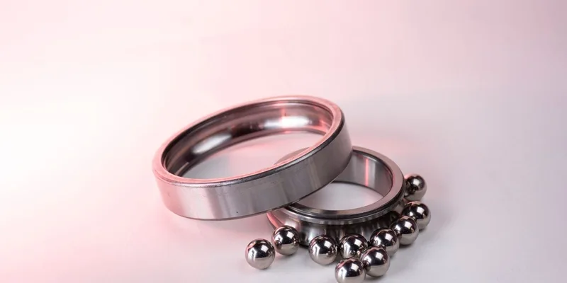 Detailed image of shiny metal bearings and rings on a white background