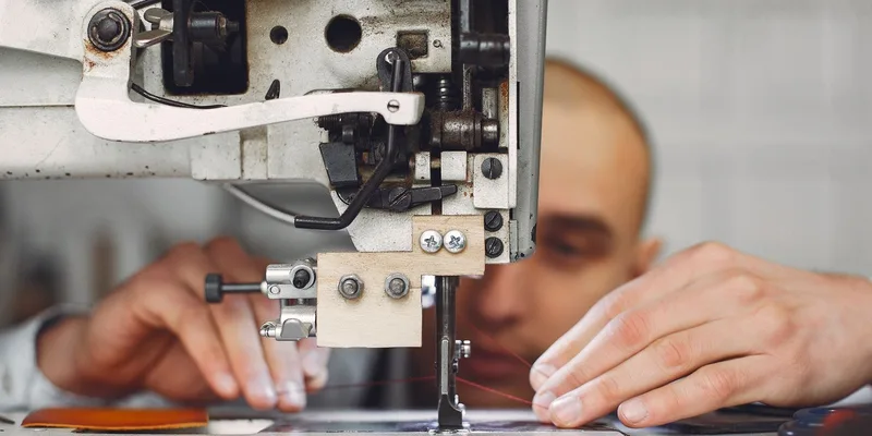 Focused artisan working with a sewing machine, emphasizing craftsmanship and precision